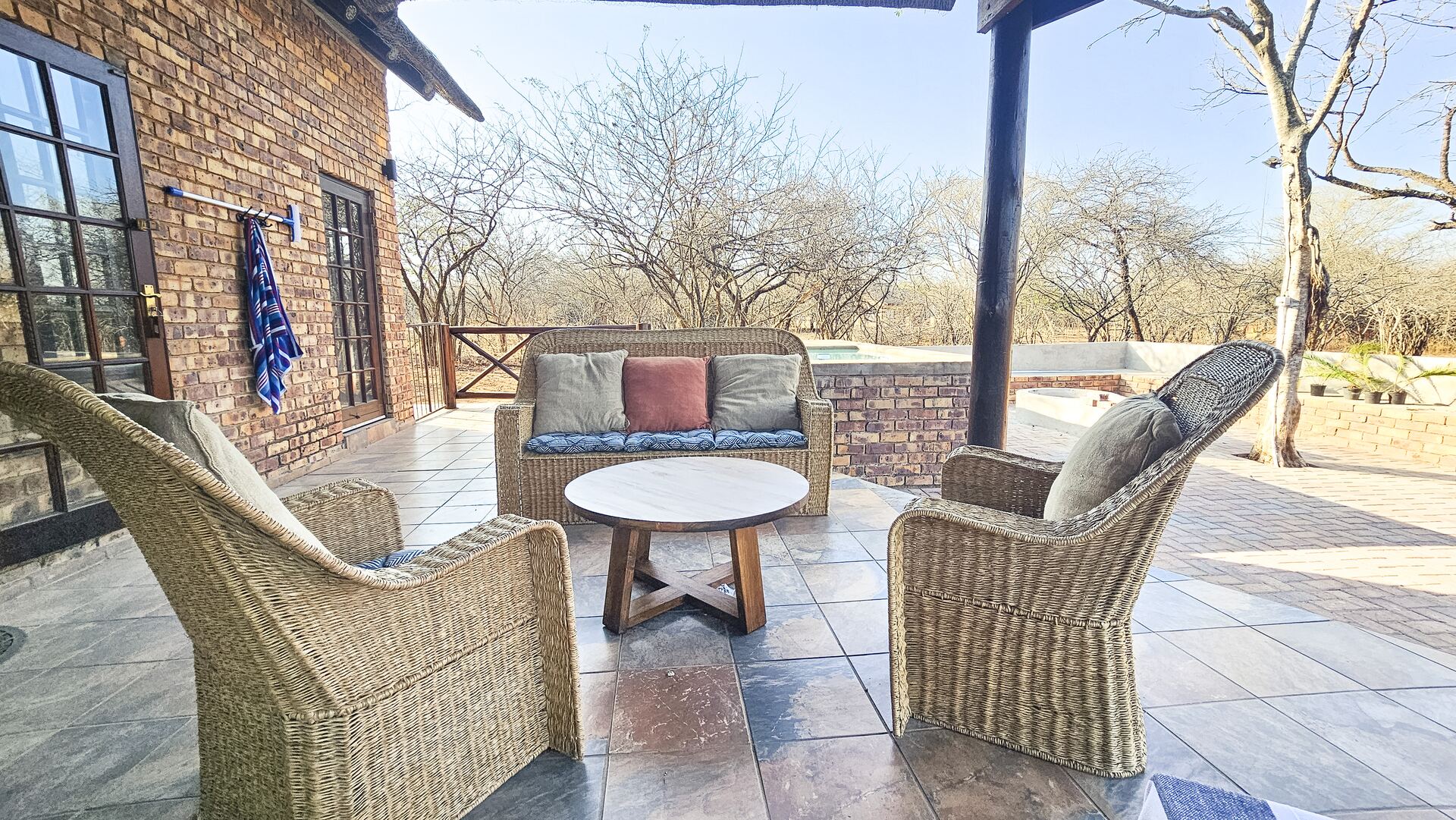 Patio seating beside the pool at Kruger Umoya